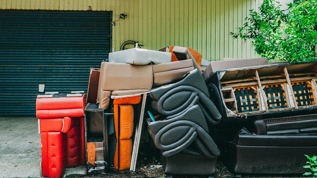 a-pile-of-trash-sitting-in-front-of-a-garage-xovdqcd6eow